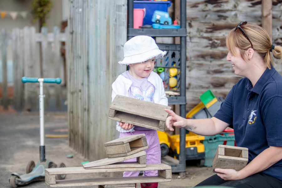 Staff playing with children at Blue Windmill Nursery