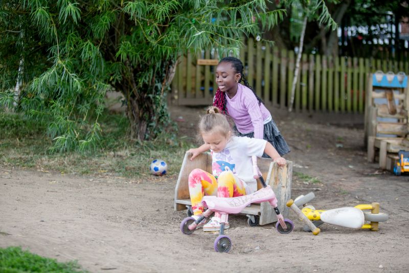 preschool children playing and laughing in the garden